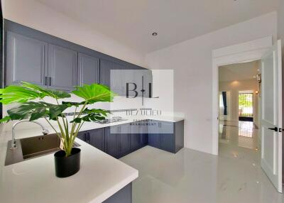 Modern kitchen with grey cabinets and white countertops