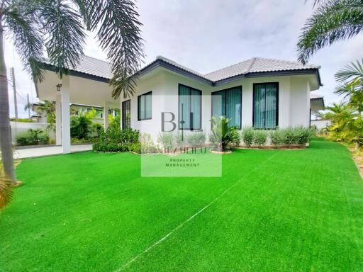 Modern single-story house with well-maintained garden