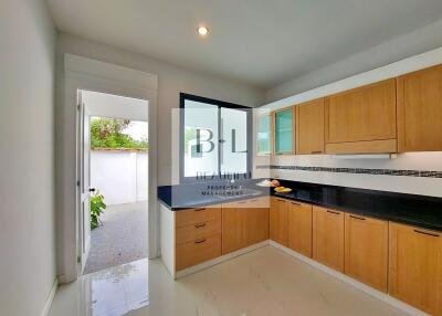 Modern kitchen with wooden cabinets and outdoor view