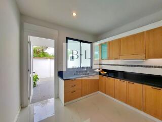 Modern kitchen with wooden cabinets and outdoor view