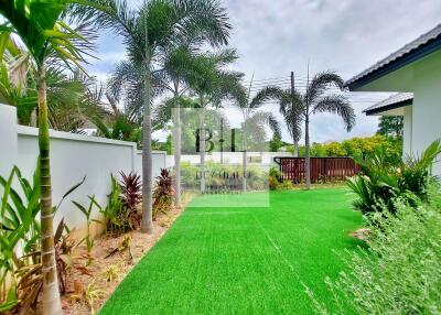 Beautifully maintained garden with lush greenery and palm trees