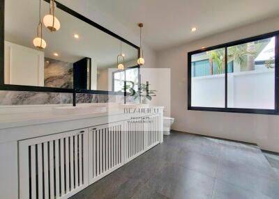 Modern bathroom with large mirror and vanity