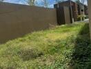 Backyard with grass and boundary wall