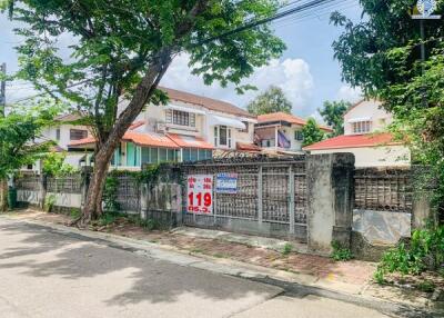 Exterior view of a residential building with a walled perimeter