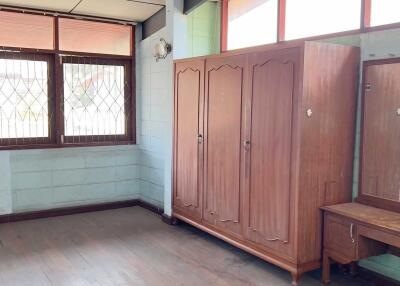 bedroom with large wardrobe and vanity