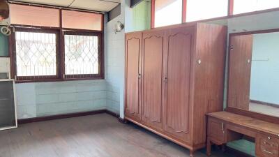 bedroom with large wardrobe and vanity