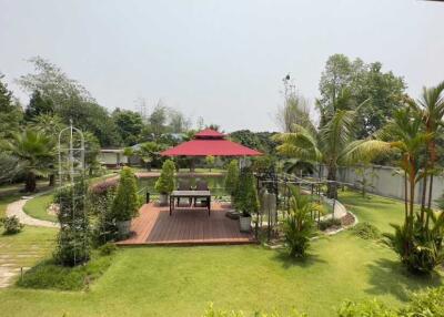 Beautifully landscaped garden with central gazebo and lush greenery