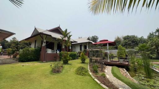 Exterior view of a house with garden and outdoor seating area