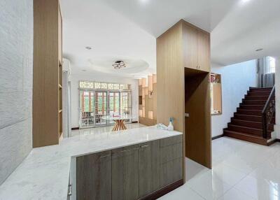 Spacious and modern main living area with staircase, large windows, and built-in storage