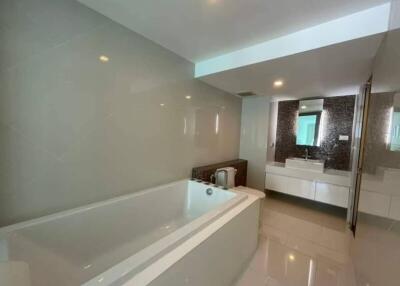 Modern bathroom with bathtub and large mirror