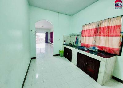 Spacious kitchen with tiles and windows