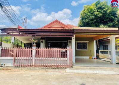 Exterior view of a house with a gated front porch and carport