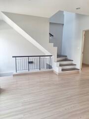 Staircase and hallway in modern home with wooden flooring and white walls