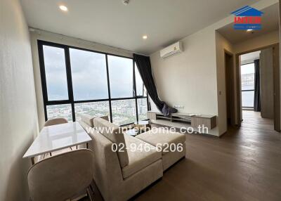Living room with large window and city view