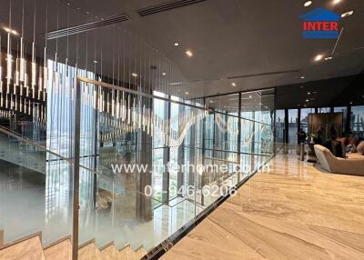 luxurious interior of a modern building with glass railings and chandeliers