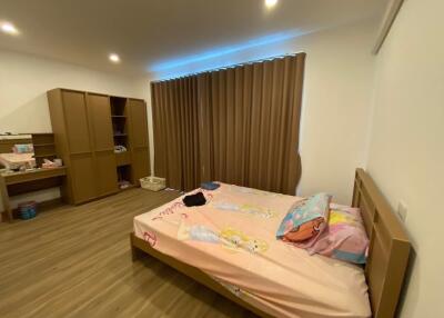 Spacious bedroom with wooden furniture and decor