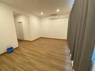 spacious living room with wooden flooring