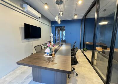 Modern office space with conference table and glass partitions