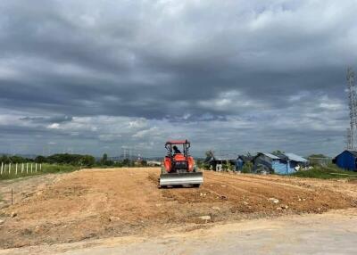 Construction site with machinery and dirt road in progress