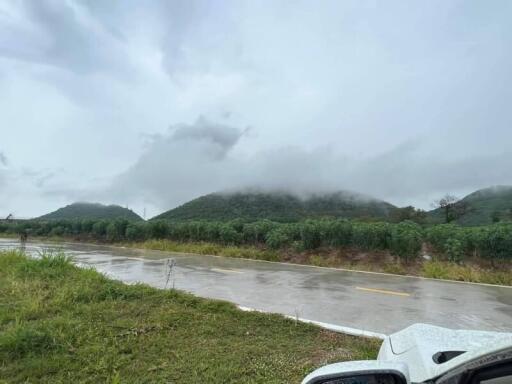 Scenic view of hills and road with cloudy sky