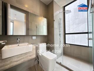 Modern bathroom with glass shower and large mirror