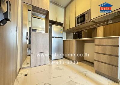 Modern kitchen with wooden cabinetry and stainless steel appliances