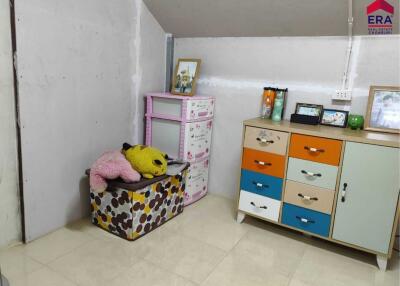 Bedroom with colorful storage units and plush toys