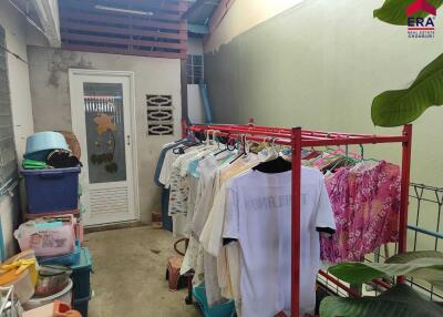 Laundry area with clothes rack and storage bins