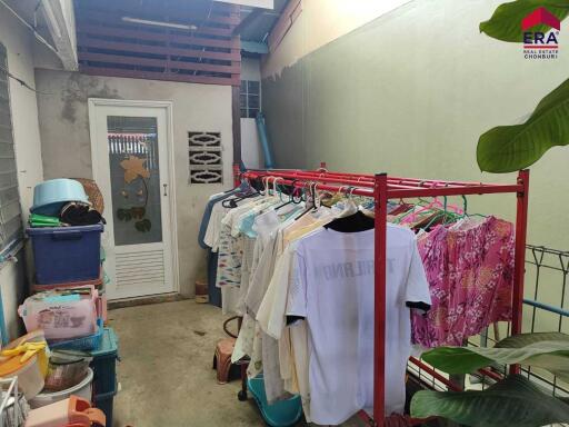 Laundry area with clothes rack and storage bins