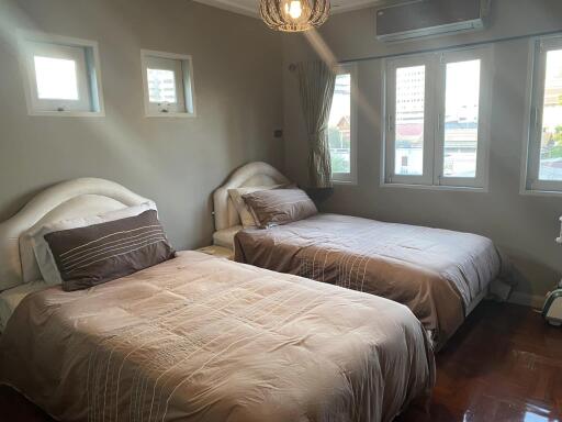 Bedroom with two beds and air-conditioning