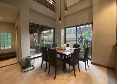 Modern dining area with large windows and high ceiling