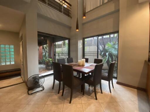 Modern dining area with large windows and high ceiling