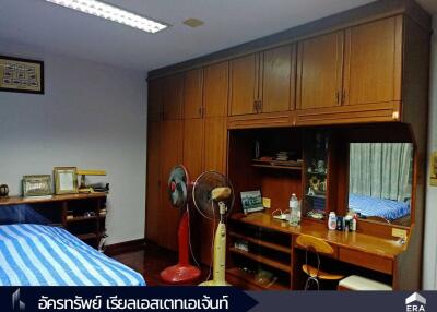 Bedroom with wooden furniture and a bed