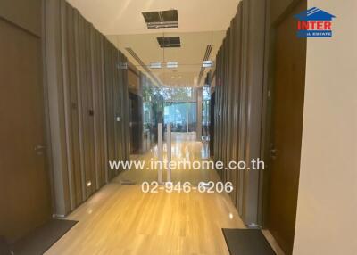 Entrance hallway with wooden flooring and glass doors