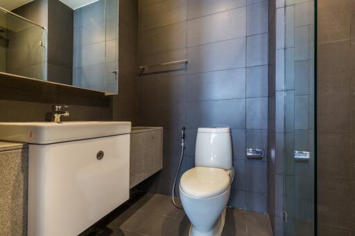 Modern bathroom with sink, toilet, and shower