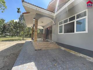 Front exterior view of the house with patio