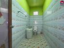 Bathroom with green walls and floral tiles