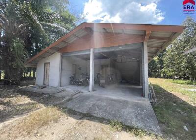 A detached building with an open garage space