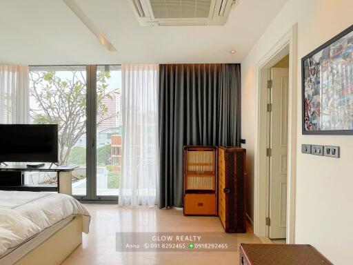 Modern bedroom with large windows and natural light