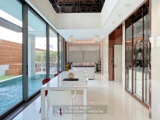 Modern dining area with adjacent living room and pool view