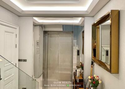 Modern hallway with glass staircase and elevator