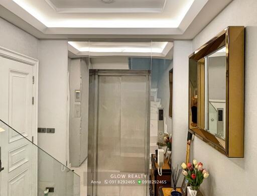 Modern hallway with glass staircase and elevator