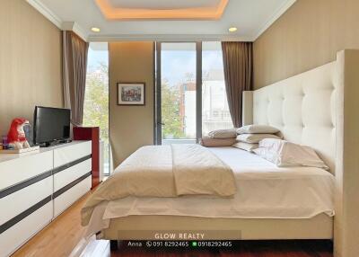 Spacious bedroom with large windows and stylish furniture