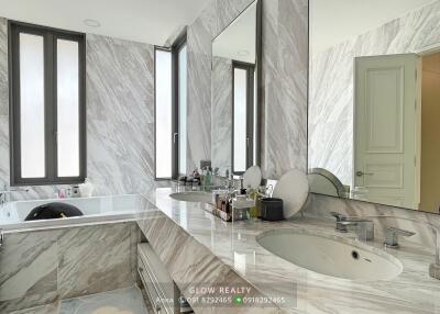 Modern bathroom with marble surfaces and large mirrors