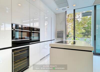 Modern white kitchen with island and built-in appliances