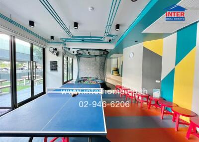 Colorful entertainment room with table tennis, large windows, and modern design