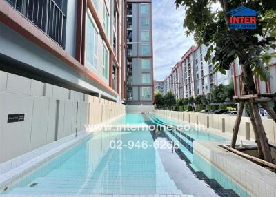 Outdoor swimming pool in front of a modern residential building