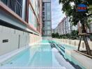 Outdoor swimming pool in front of a modern residential building