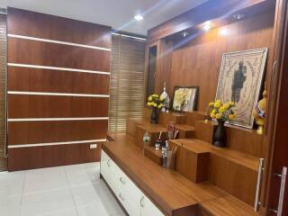 Modern living room with wooden paneling and shelving