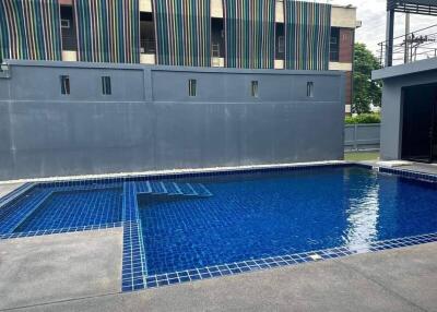 Outdoor swimming pool with modern tiling